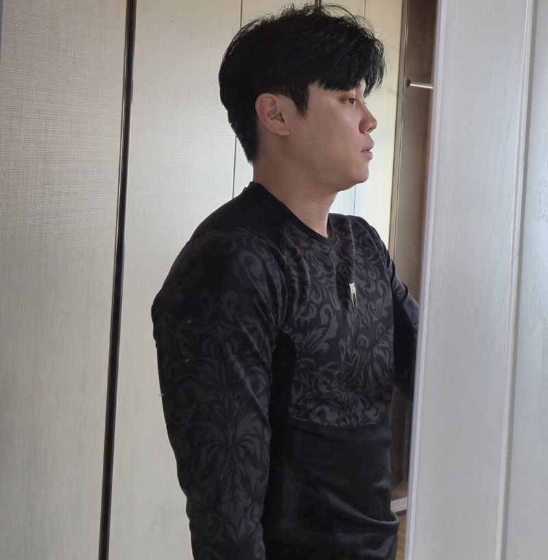 A man in black clothes looking sideways