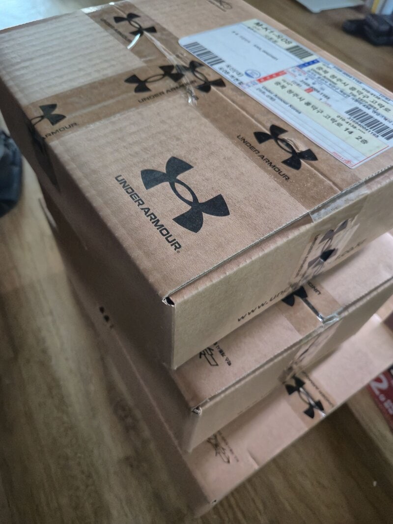 Three delivery boxes with the Under Armour logo.