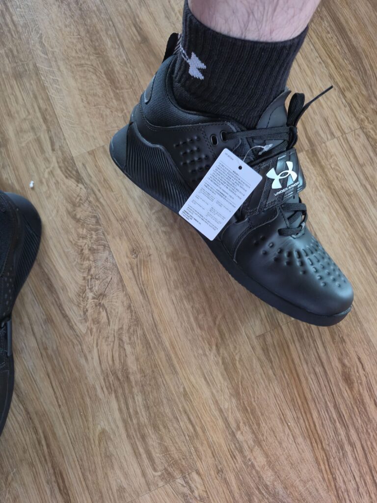 Photo of someone wearing Under Armour lifting shoes.