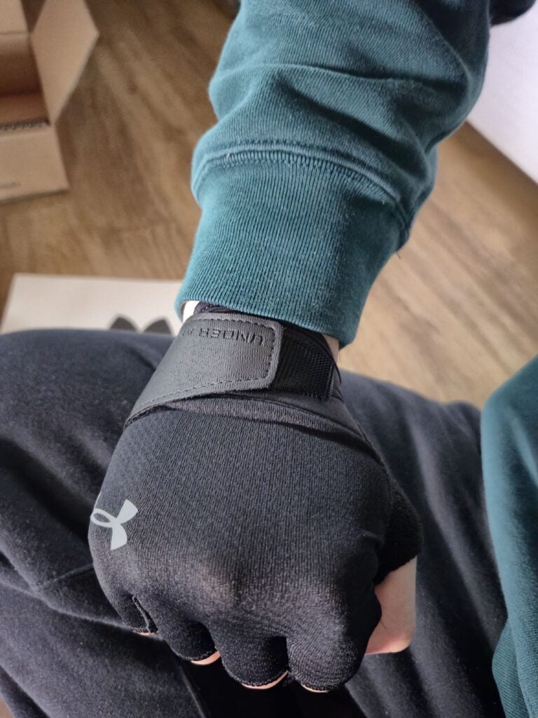 Photo of someone wearing Under Armour gloves.