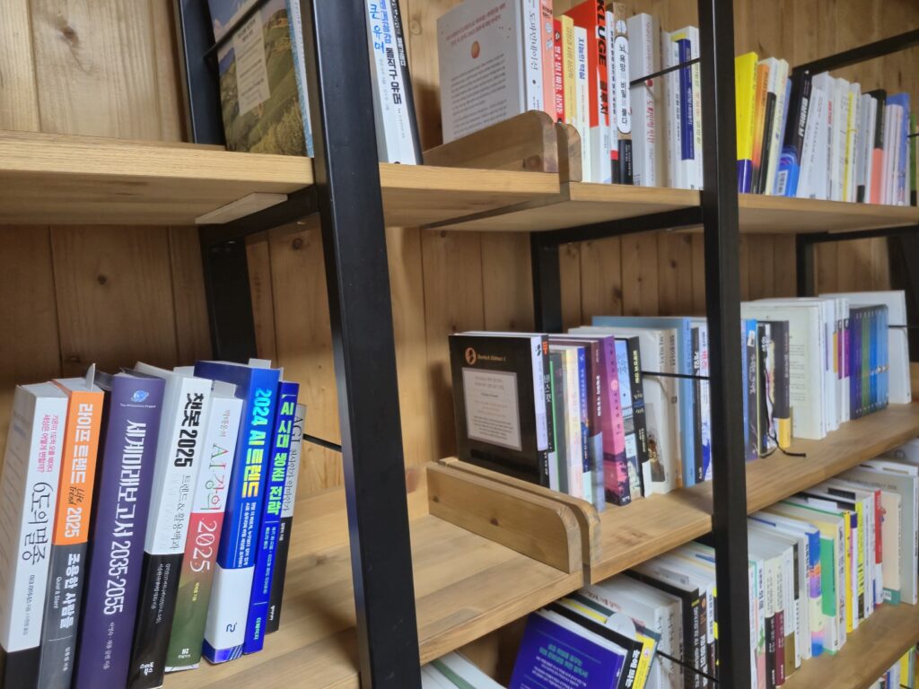 An angled shot showcasing the solid, smooth surface and subtle, luxurious grain of the newly installed solid wood and iron bookshelf shelves.